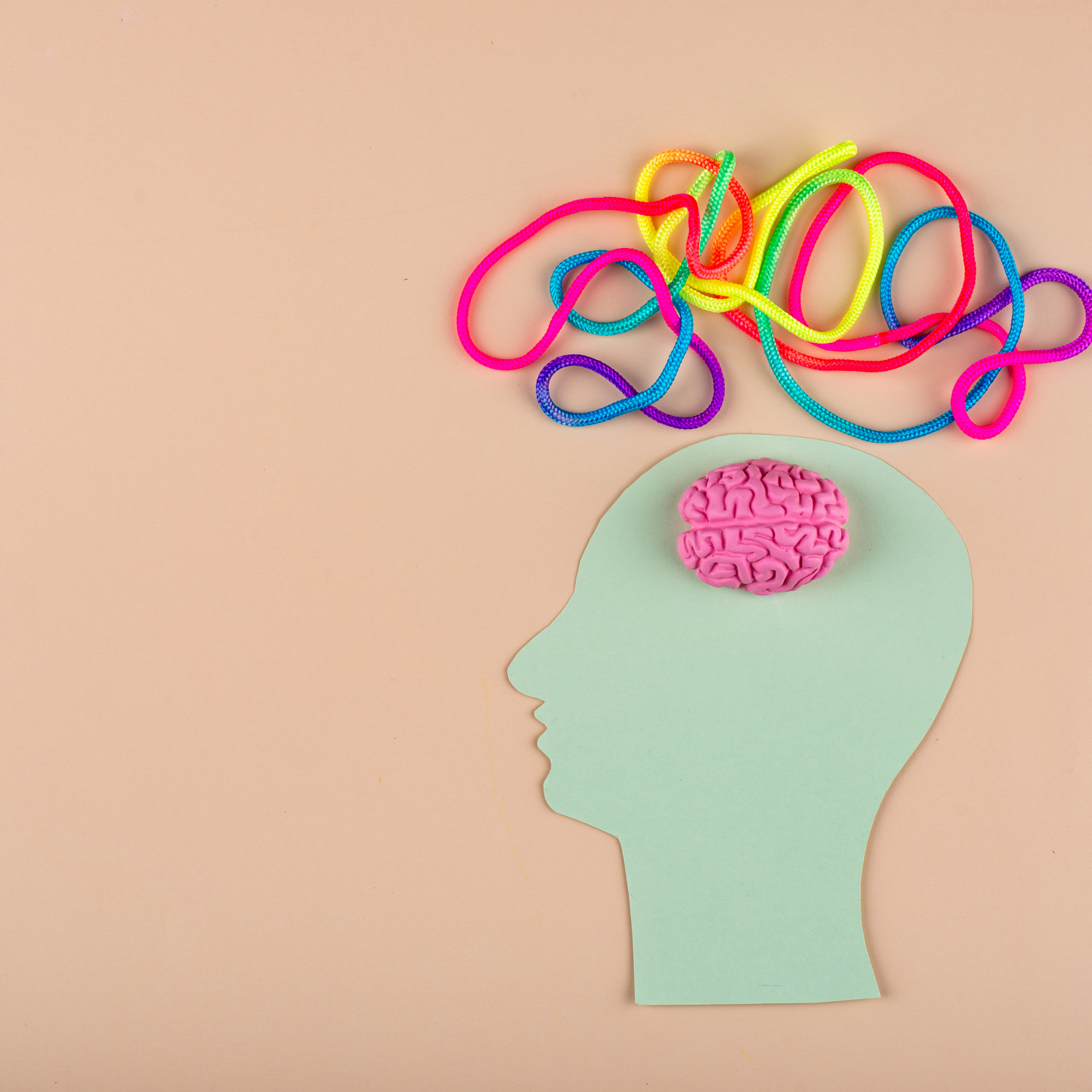 Young girl reading a book with a teddy bear on a cozy sofa